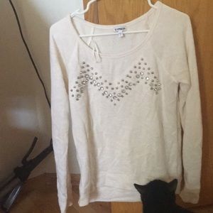 White jeweled long sleeve shirt.